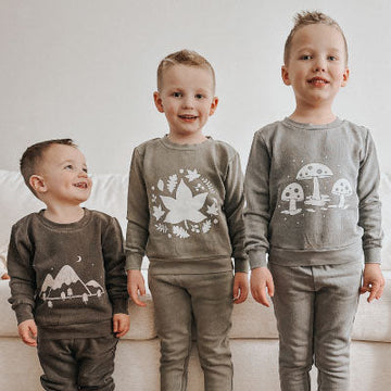 Three children wearing matching outfits