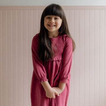 A girl wearing a red dress.