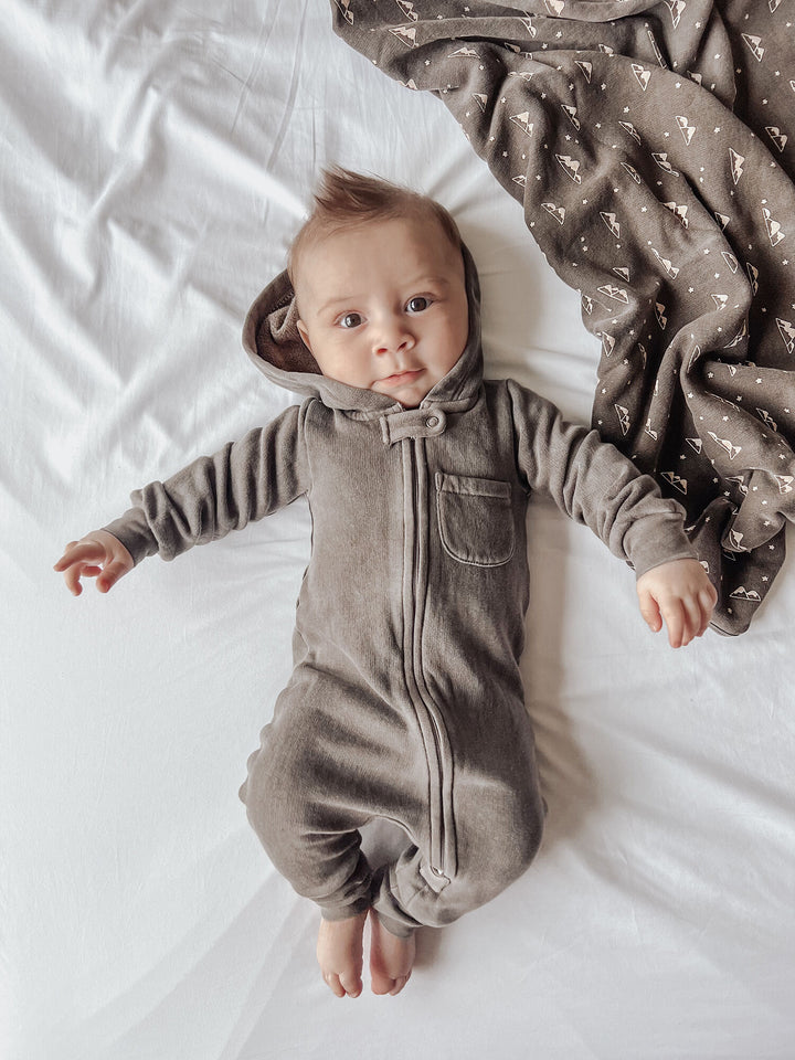 Child wearing Organic Cozy Zipper Romper in Bark.