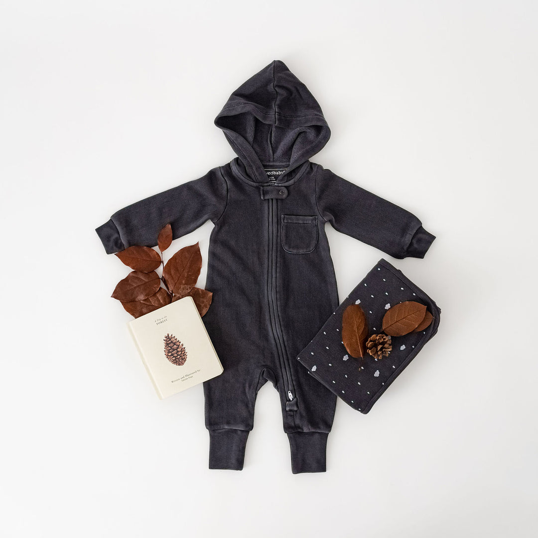 Child wearing Organic Cozy Zipper Romper in Coal.