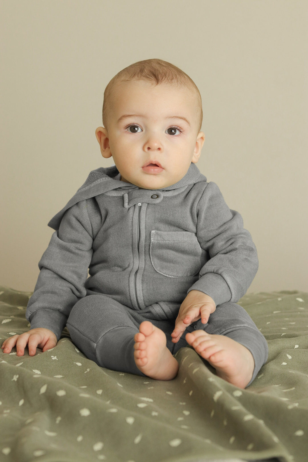 Child wearing Organic Cozy Zipper Romper in Mist.