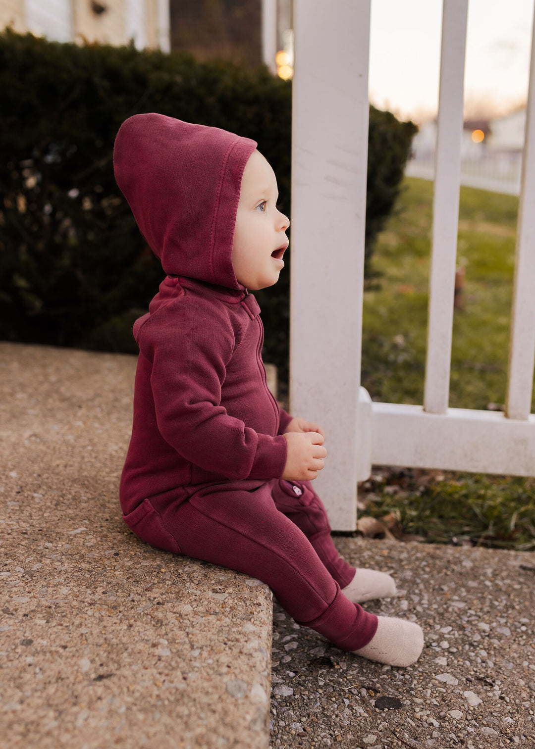 Child wearing Organic Cozy Zipper Romper in Sugarplum.