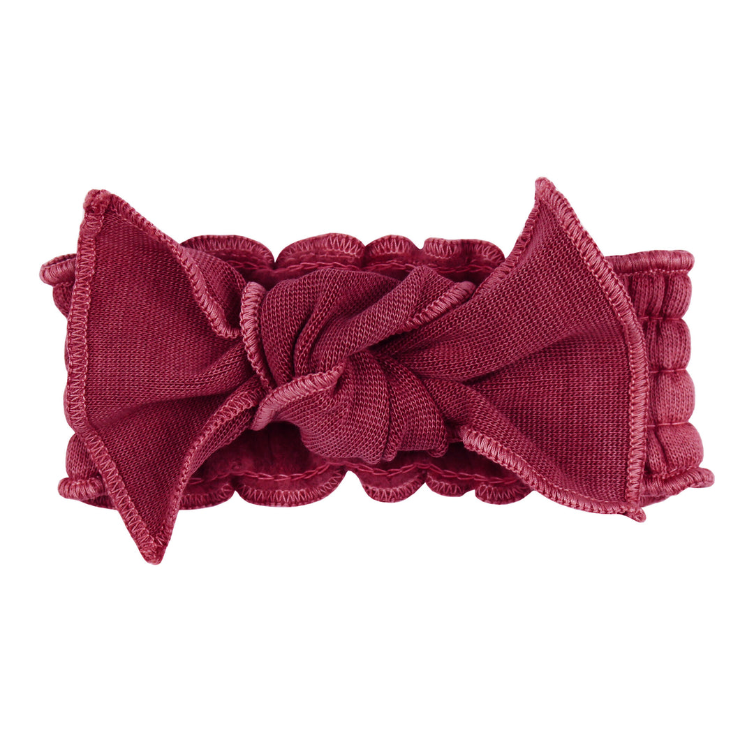 Organic Cozy Smocked Headband in Sugarplum, a dark red purplish color.