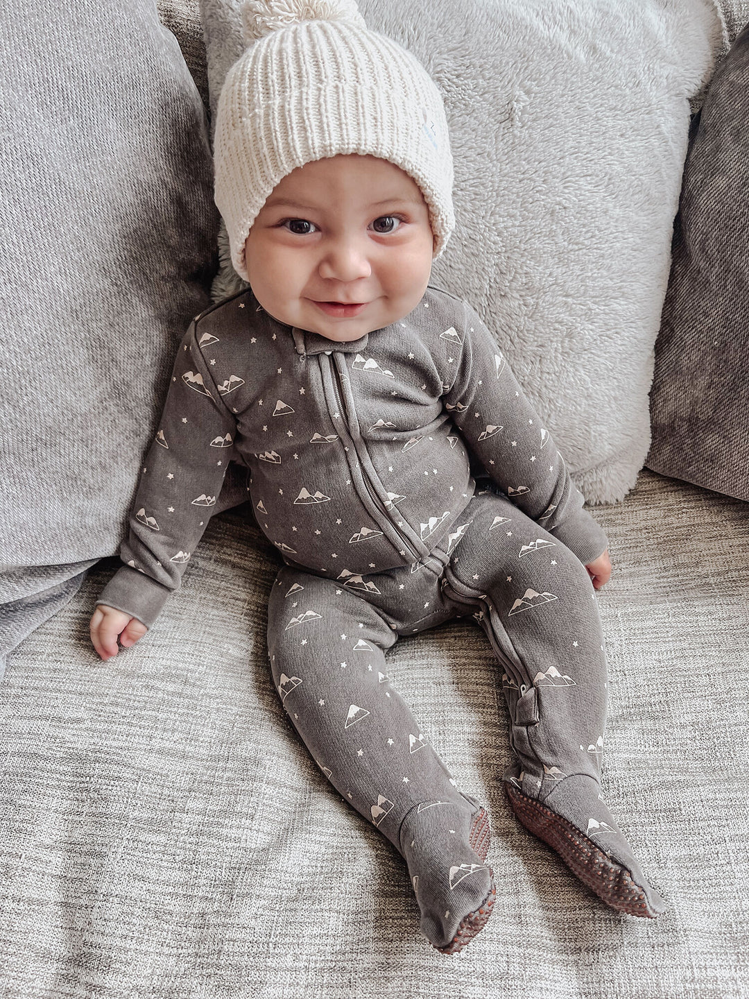 Child wearing Organic Cozy 2-Way Zipper Footie in Bark Mountains.