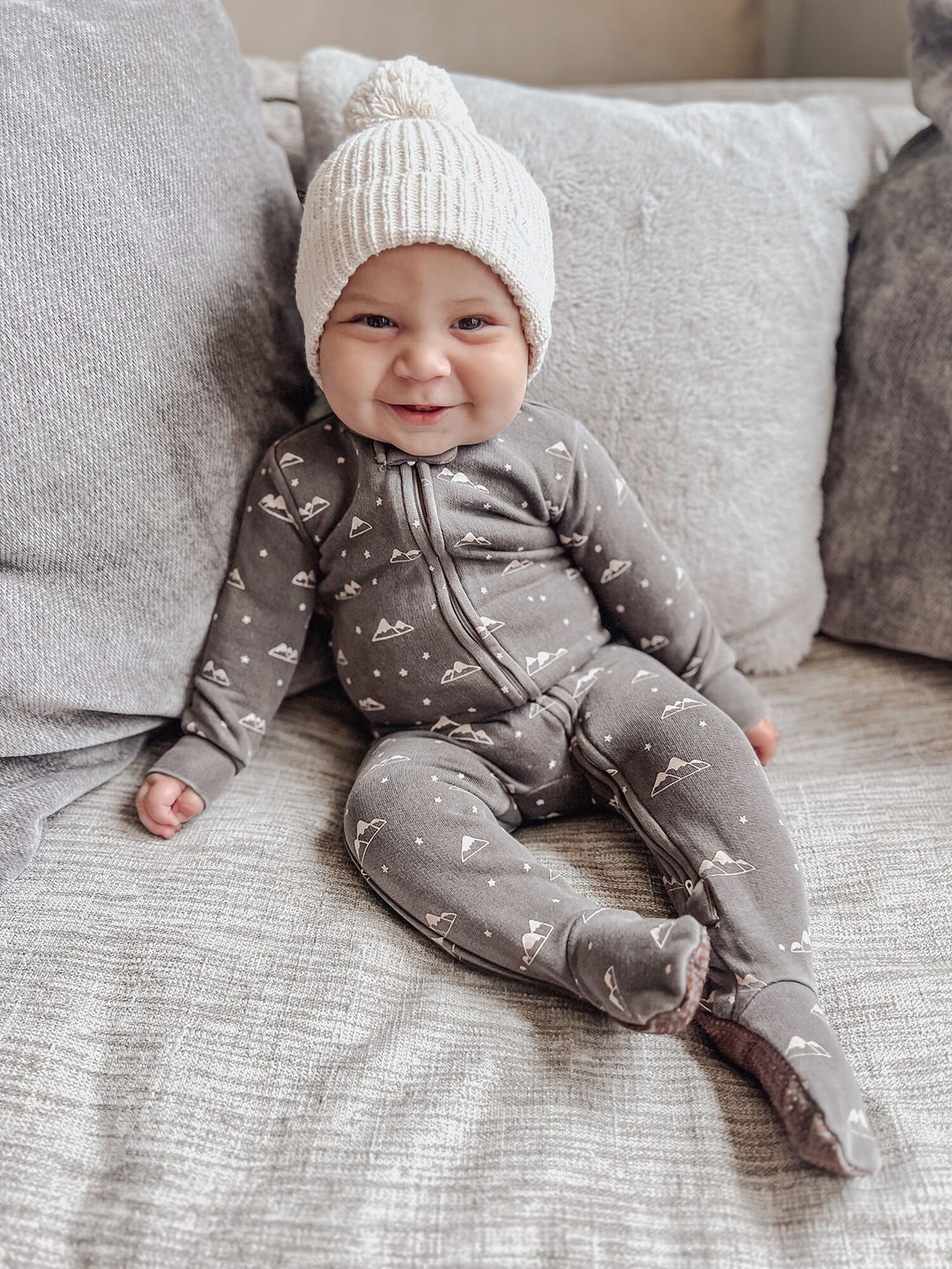 Child wearing Organic Cozy 2-Way Zipper Footie in Bark Mountains.