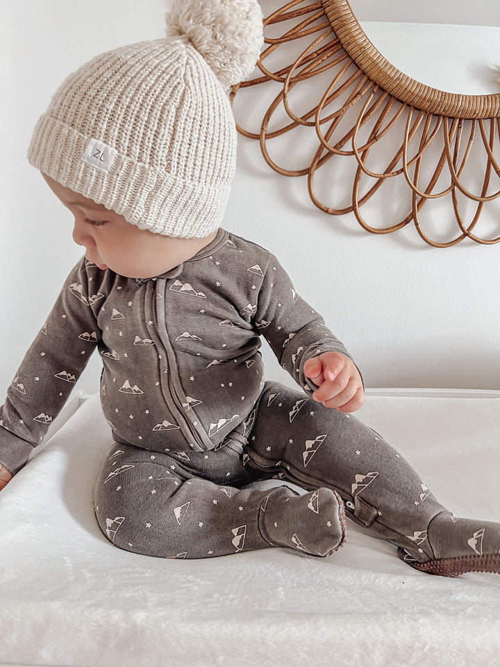 Child wearing Organic Cozy 2-Way Zipper Footie in Bark Mountains.