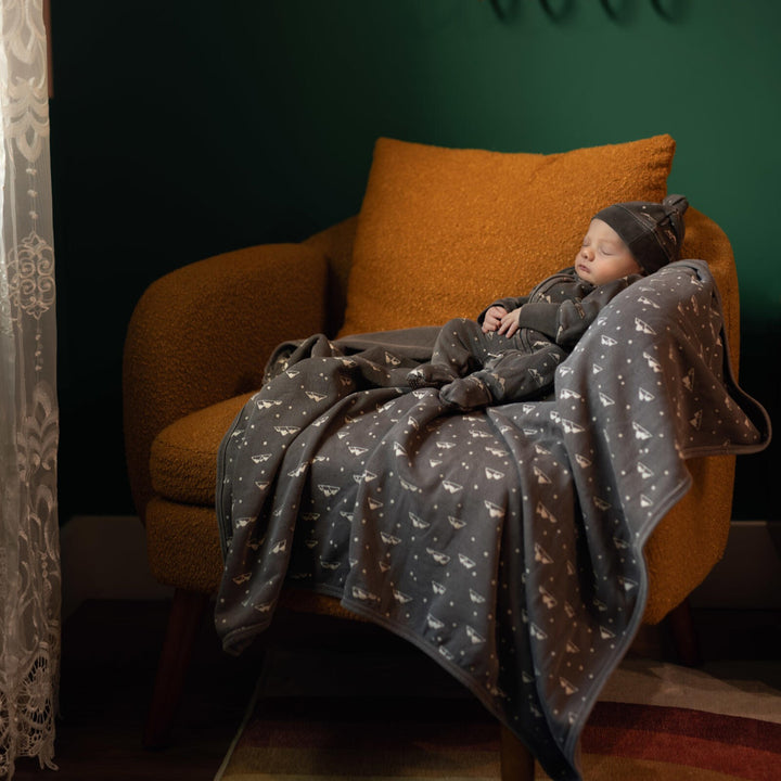 Child wearing Organic Cozy Blanket in Bark Mountains.