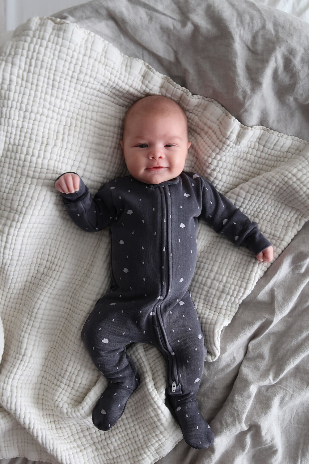 Child wearing Organic Cozy 2-Way Zipper Footie in Coal Clouds.