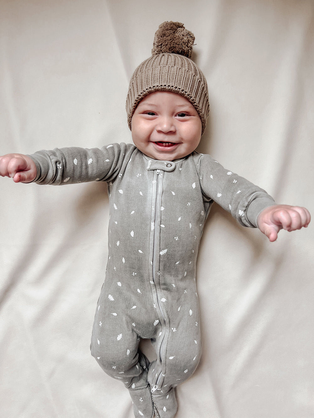 Child wearing Organic Cozy 2-Way Zipper Footie in Hunter Leaves.