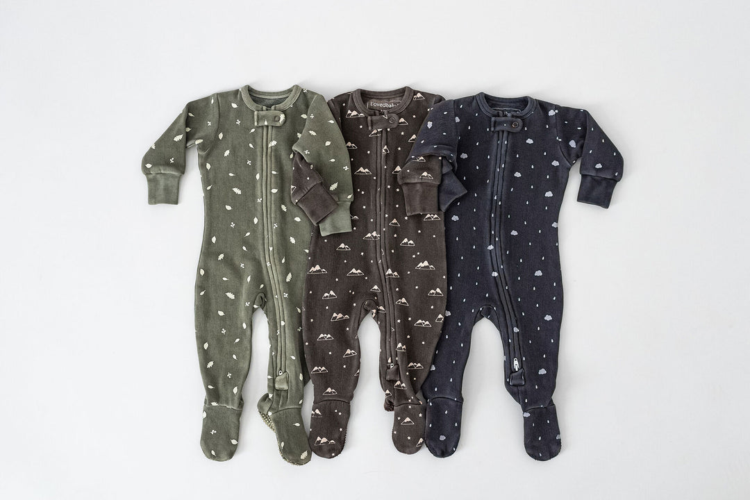 Child wearing Organic Cozy 2-Way Zipper Footie in Hunter Leaves.