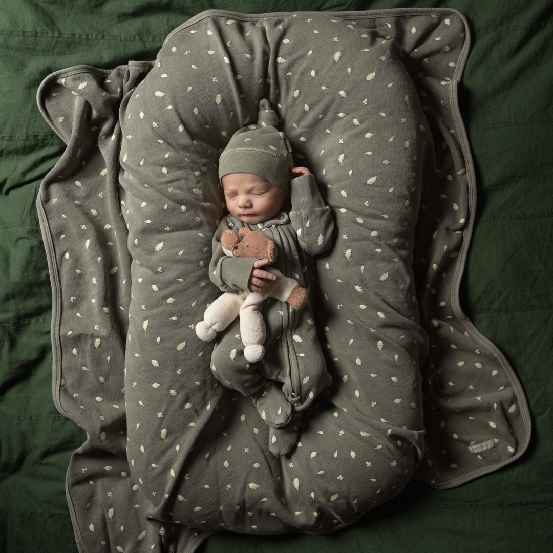 Child wearing Organic Cozy 2-Way Zipper Footie in Hunter Leaves.