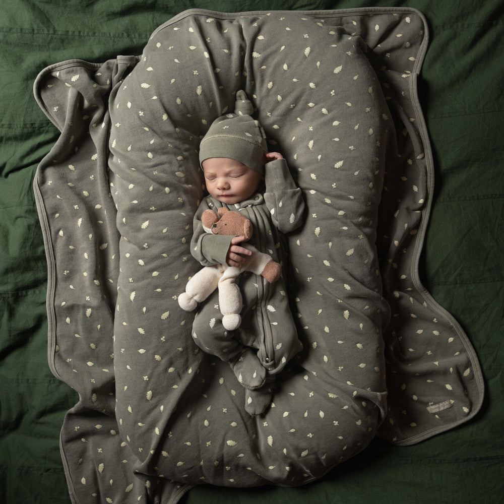 Child wearing Organic Cozy Blanket in Hunter Leaves.