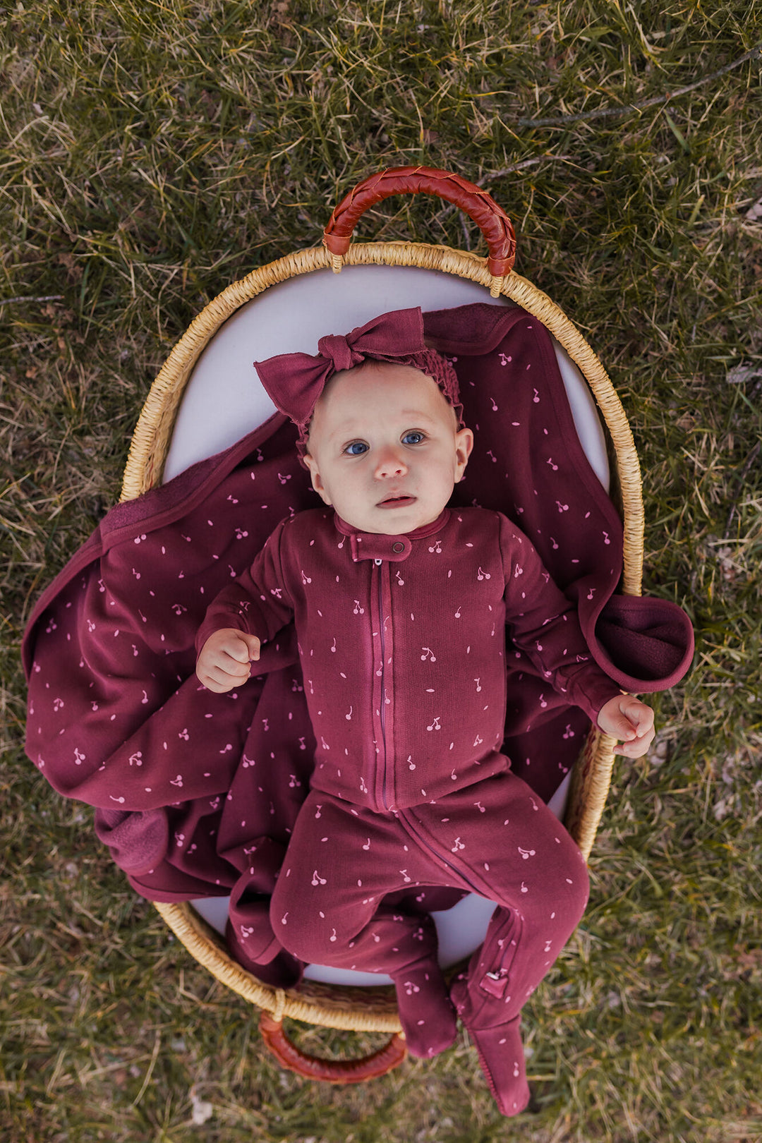 Child wearing Organic Cozy 2-Way Zipper Footie in Sugarplum Cherries.