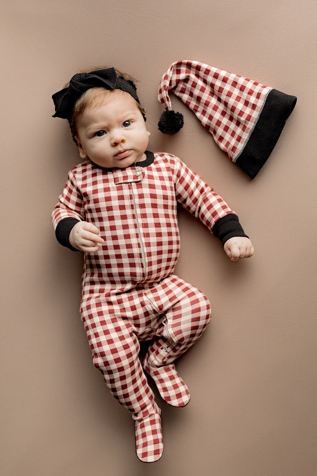 Child wearing Holiday 2-Way Zipper Footie & Cap Set in Crimson Plaid.