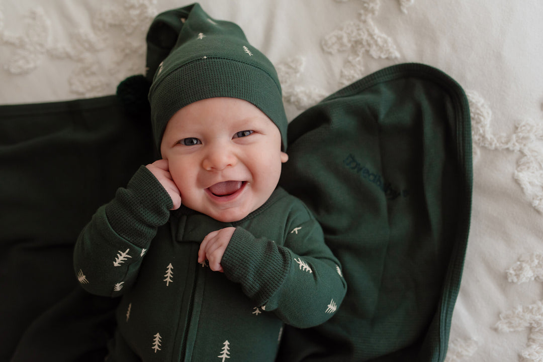 Child wearing Holiday 2-Way Zipper Footie & Cap Set in Pine Trees.