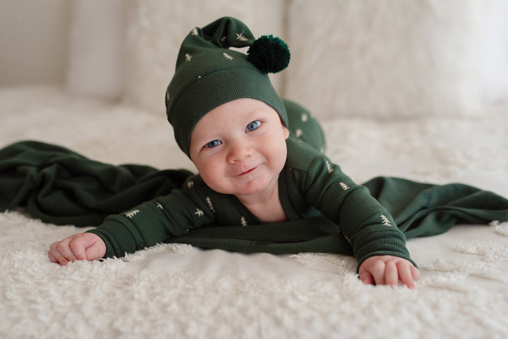 Child wearing Holiday 2-Way Zipper Footie & Cap Set in Pine Trees.