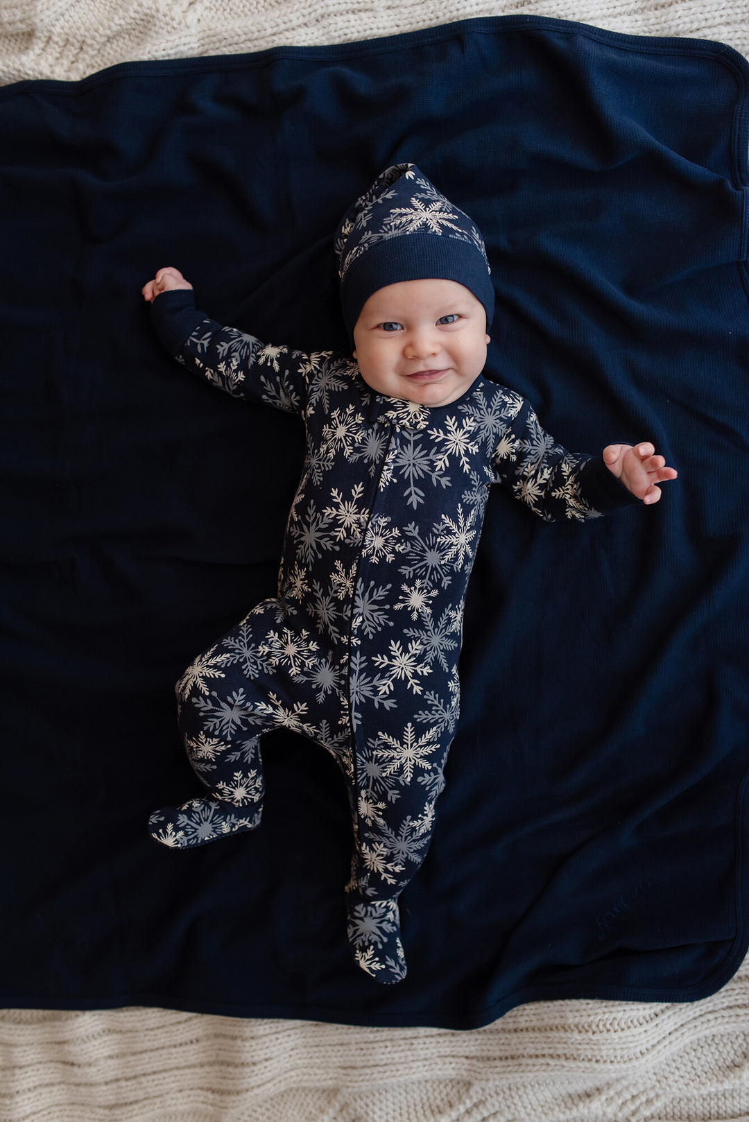 Child wearing Holiday 2-Way Zipper Footie & Cap Set in Snowflakes.