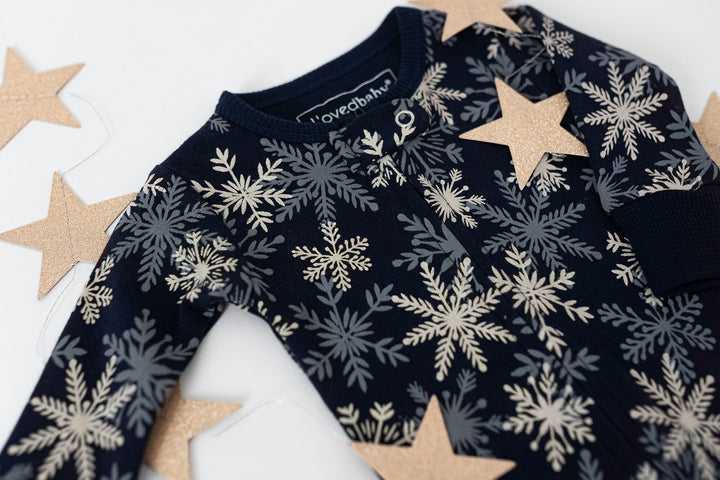 Child wearing Holiday 2-Way Zipper Footie & Cap Set in Snowflakes.