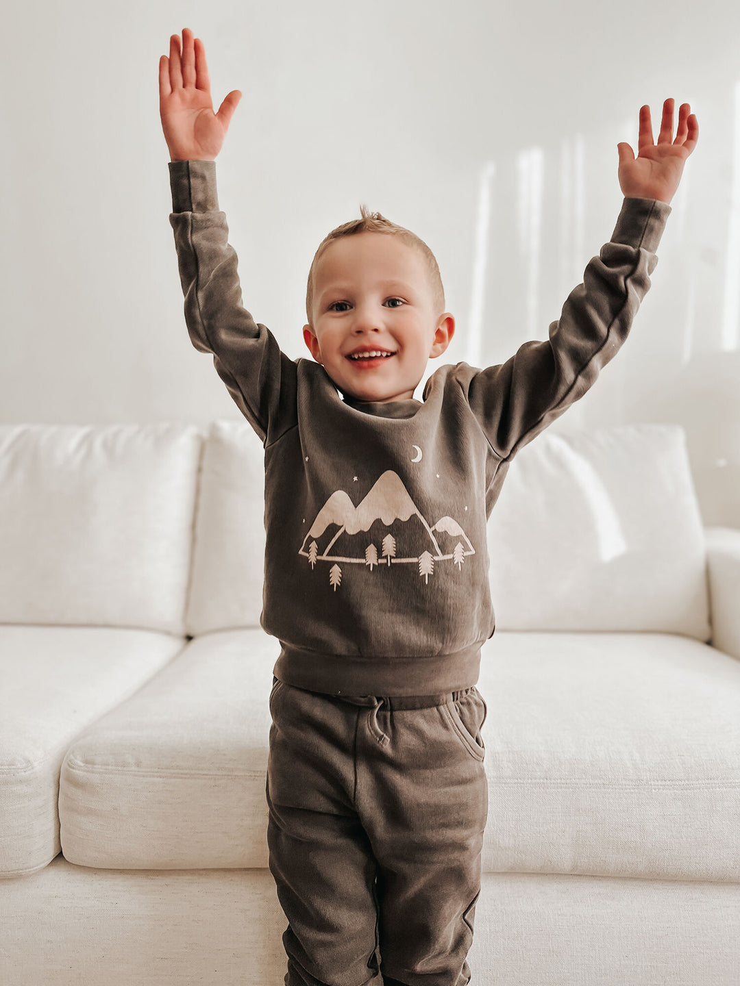 Child wearing Kids' Organic Cozy Graphic Sweatshirt & Jogger Set in Bark Mountains.