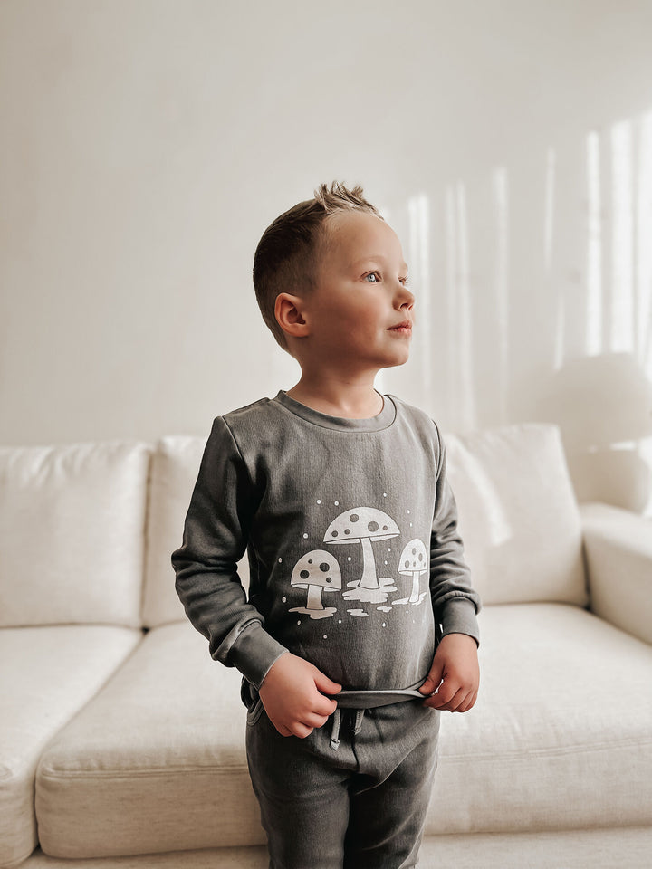 Child wearing Kids' Organic Cozy Graphic Sweatshirt & Jogger Set in Mist Mushrooms.