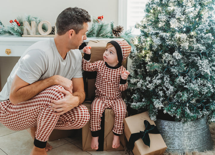 Child wearing Kids' Organic Holiday PJ & Cap Set in Crimson Plaid.