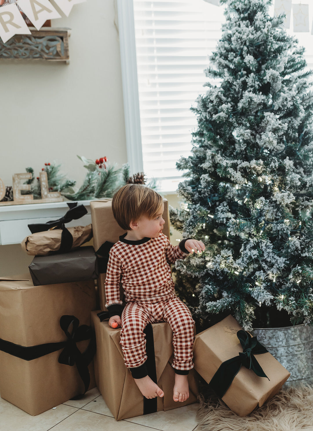 Child wearing Kids' Organic Holiday PJ & Cap Set in Crimson Plaid.