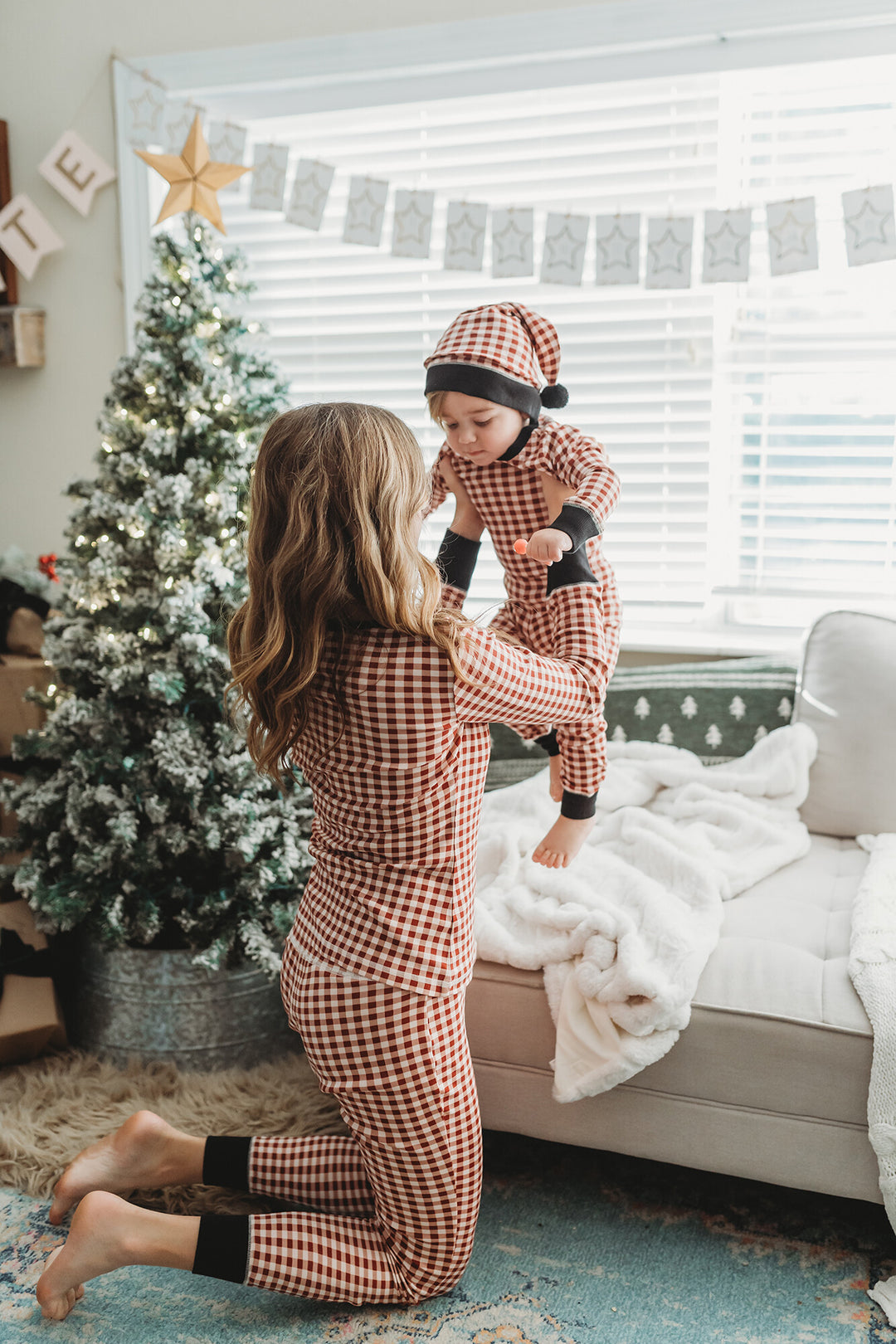 Child wearing Kids' Organic Holiday PJ & Cap Set in Crimson Plaid.