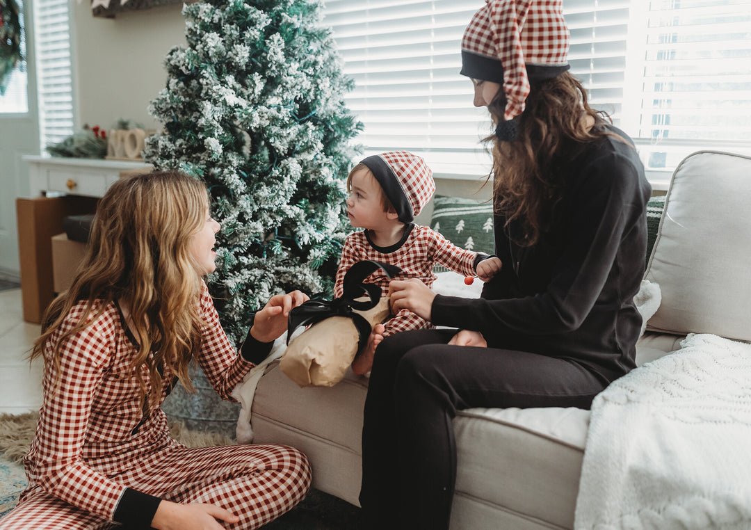 Child wearing Kids' Organic Holiday PJ & Cap Set in Crimson Plaid.