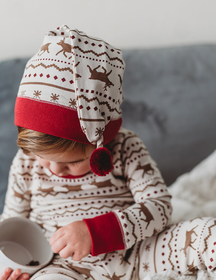 Child wearing Kids' Organic Holiday PJ & Cap Set in Fair Isle Rudolph.