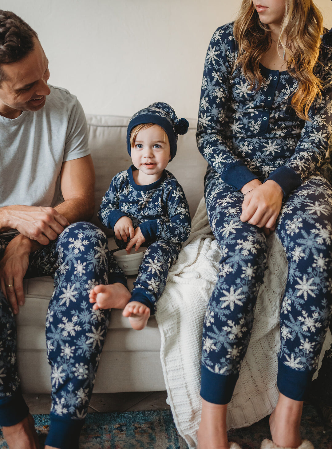 Child wearing Kids' Organic Holiday PJ & Cap Set in Snowflakes.