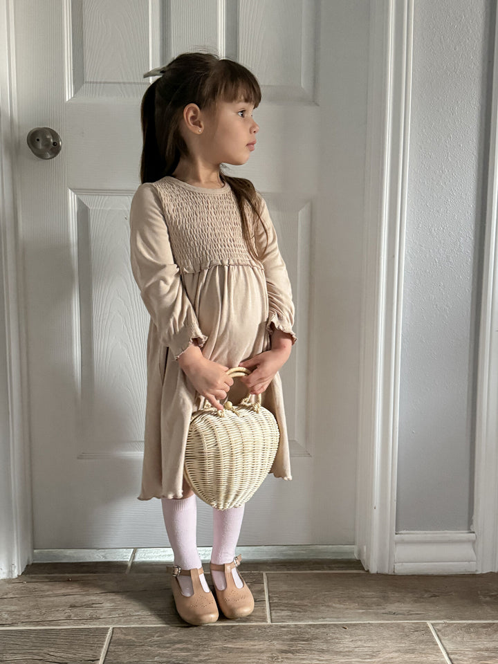 Child wearing Kid's Organic Smocked Dress in Oatmeal.