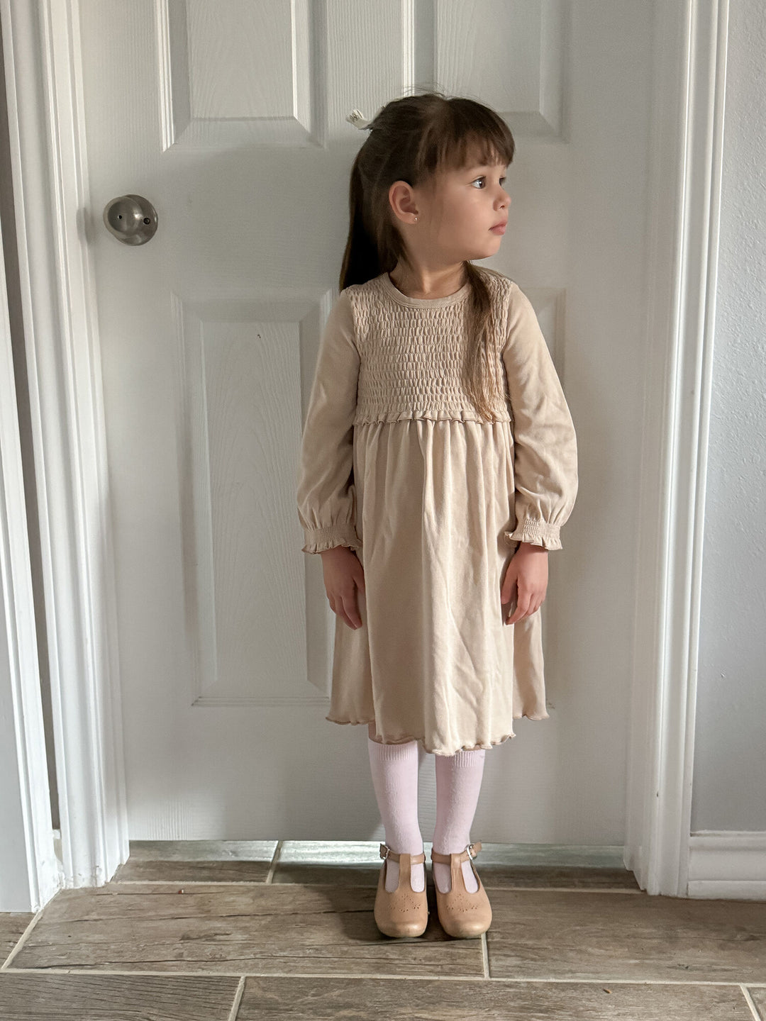 Child wearing Kid's Organic Smocked Dress in Oatmeal.