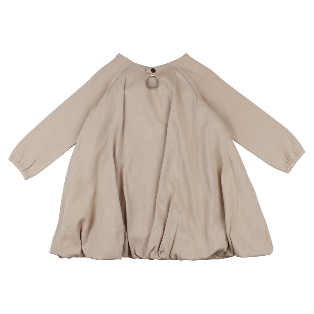 Back view of Kid's Organic Bubble Dress in Oatmeal, a light tan color.