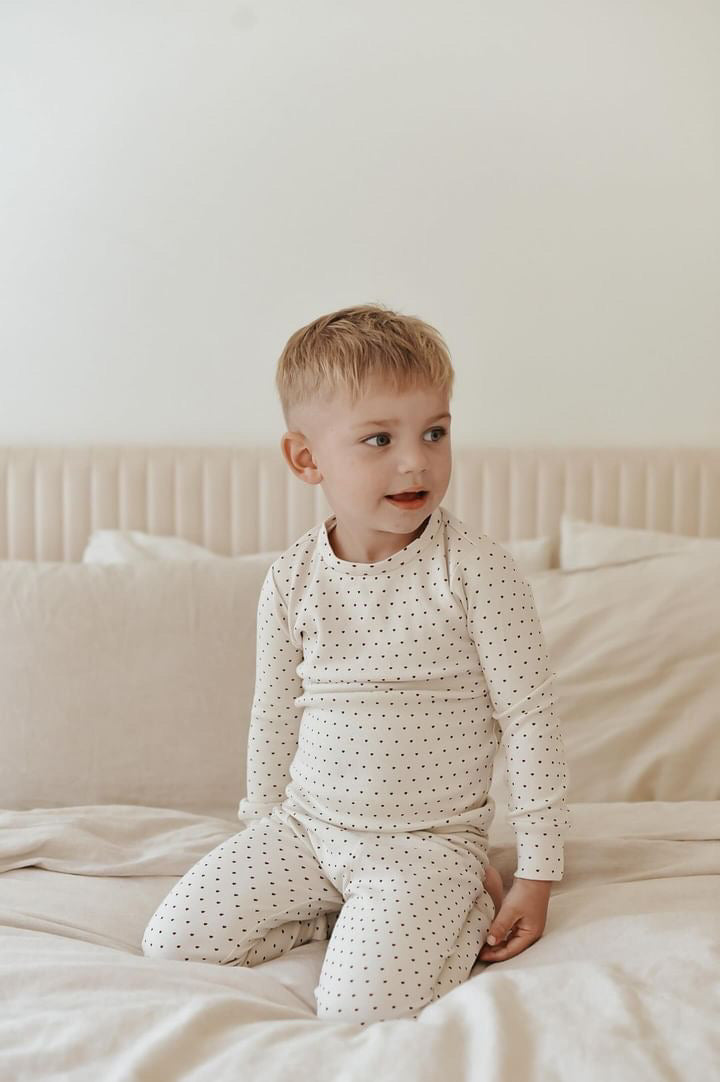 Child wearing Kids' Organic L/Sleeve PJ Set in Crimson Mini Hearts.