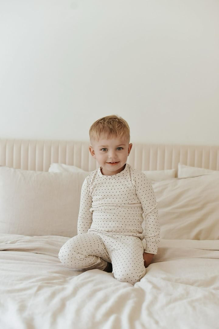 Child wearing Kids' Organic L/Sleeve PJ Set in Crimson Mini Hearts.