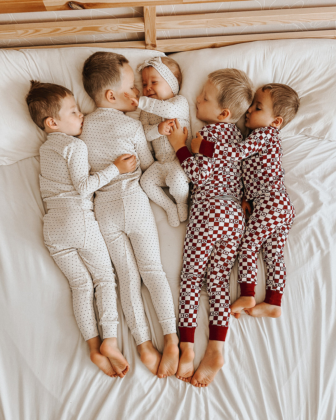 Child wearing Kids' Organic L/Sleeve PJ Set in Crimson Mini Hearts.