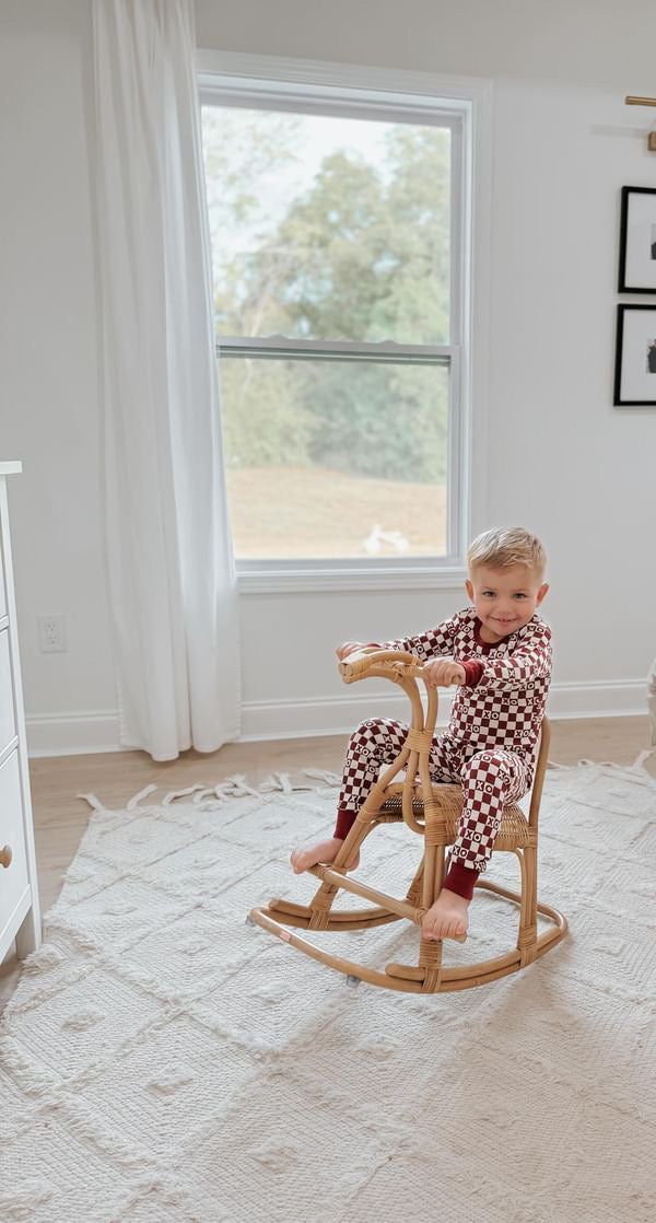 Child wearing Kids' Organic L/Sleeve PJ Set in Crimson XO Checker.