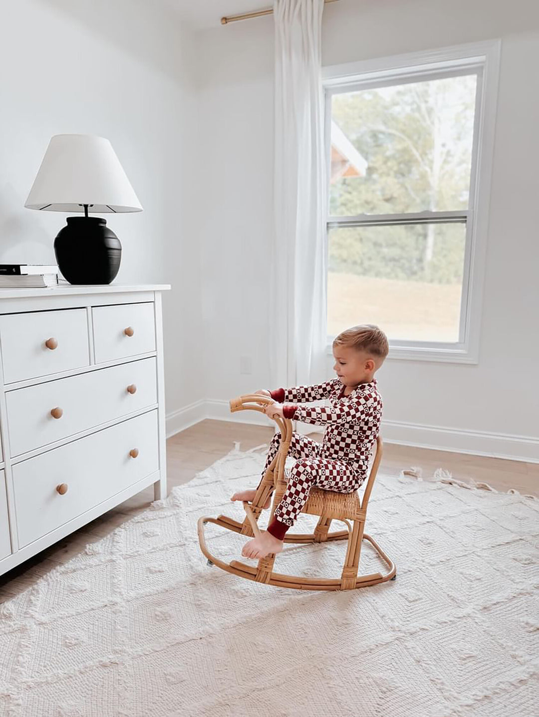 Child wearing Kids' Organic L/Sleeve PJ Set in Crimson XO Checker.