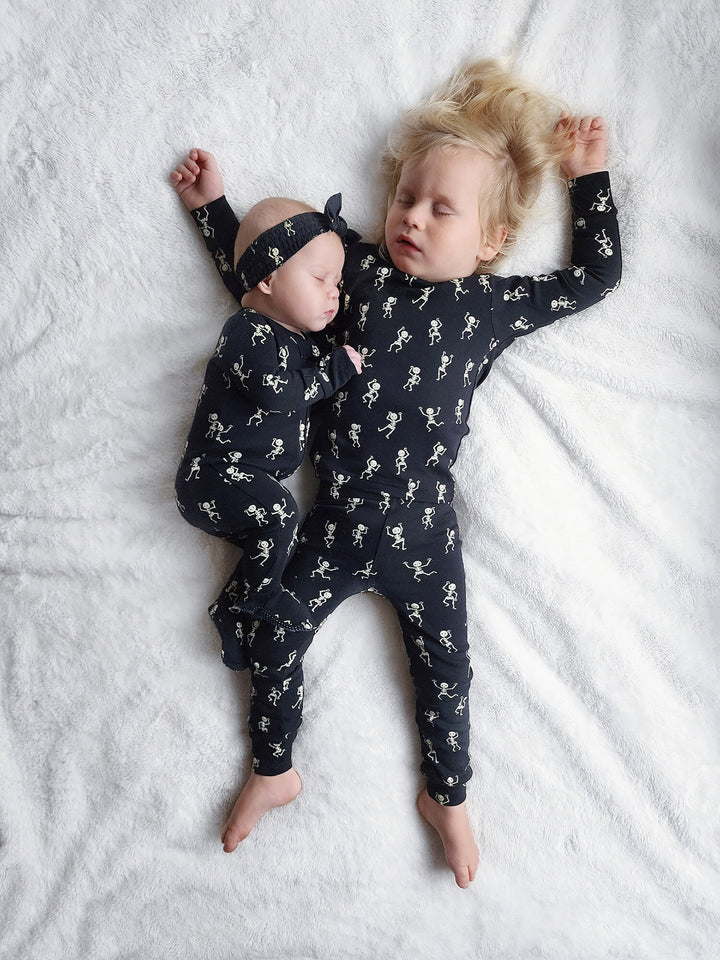 Child wearing Kids' Organic L/Sleeve PJ Set in Dancing Skeletons.