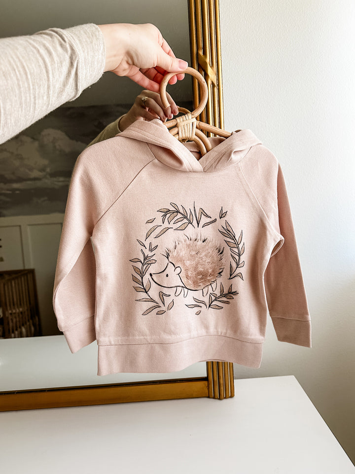 Child wearing Kids' Organic Printed Raglan Hoodie in Prickles Graphic.