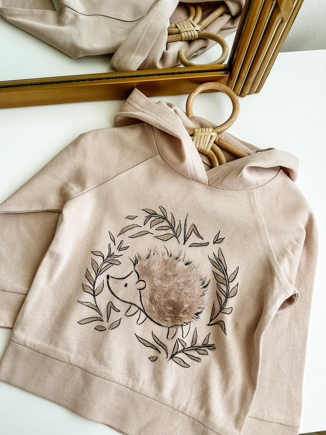 Child wearing Kids' Organic Printed Raglan Hoodie in Prickles Graphic.