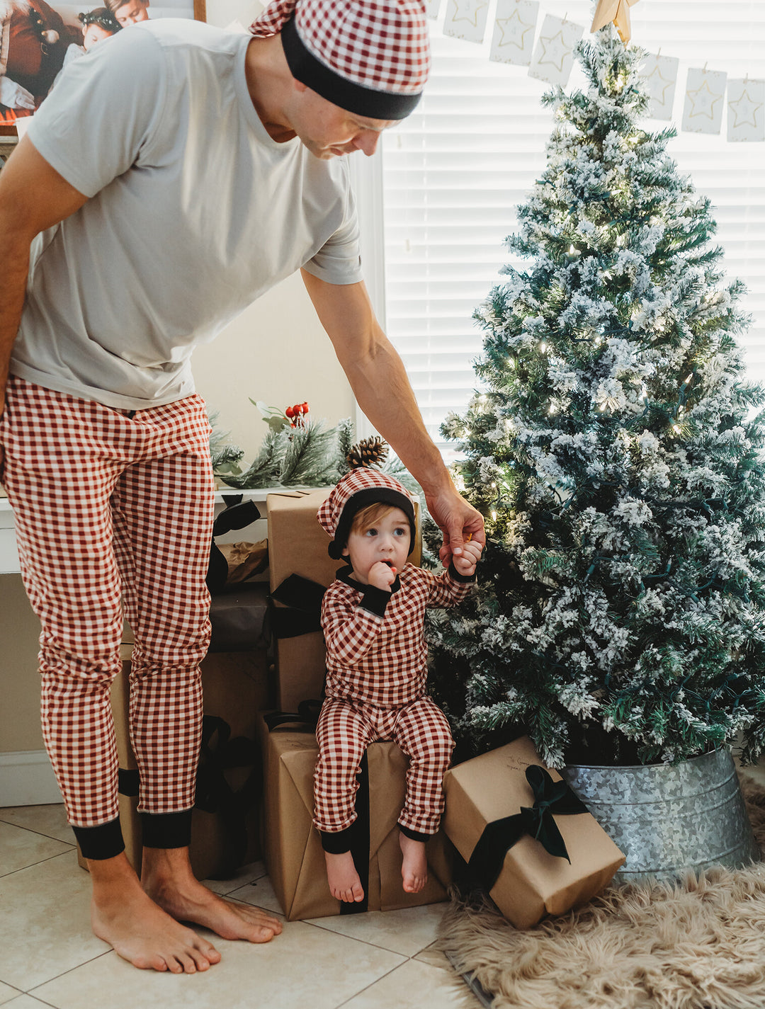 Child wearing Men's Organic Holiday Jogger & Cap Set in Crimson Plaid.