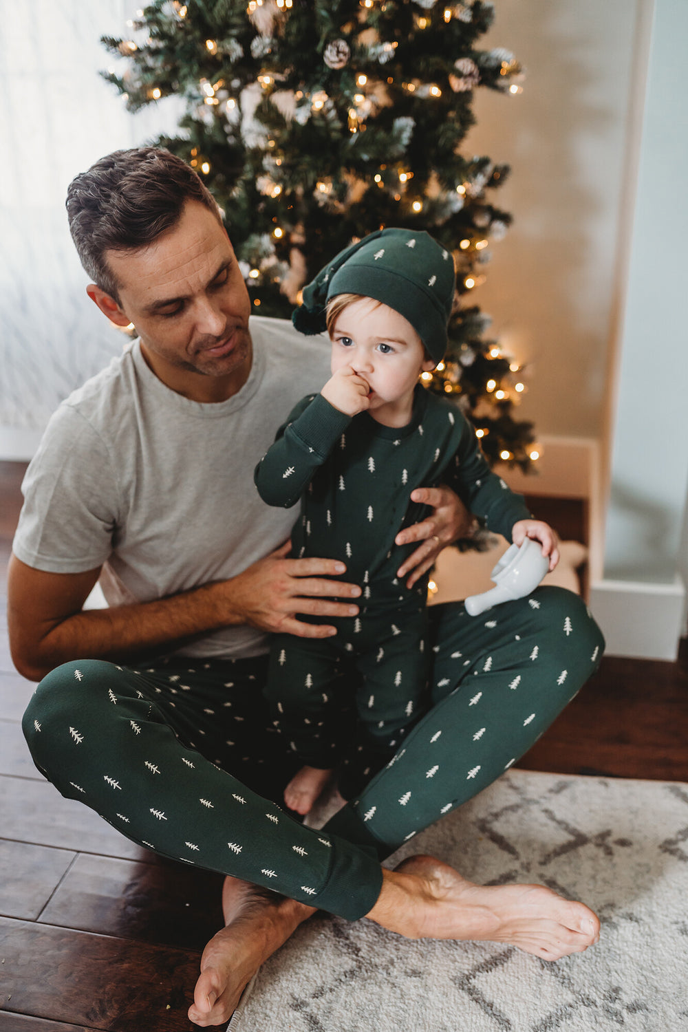 Child wearing Men's Organic Holiday Jogger & Cap Set in Pine Trees.