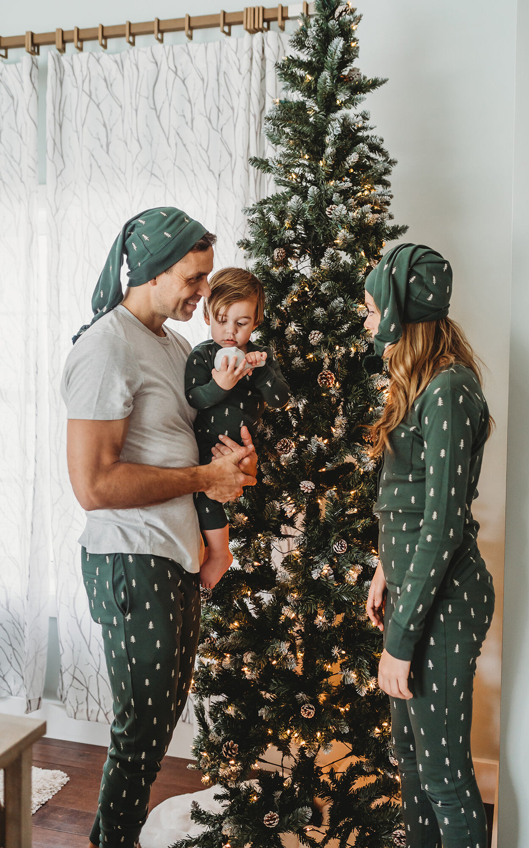 Child wearing Men's Organic Holiday Jogger & Cap Set in Pine Trees.