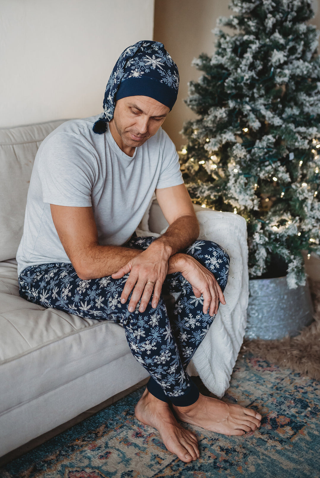 Child wearing Men's Organic Holiday Jogger & Cap Set in Snowflakes.