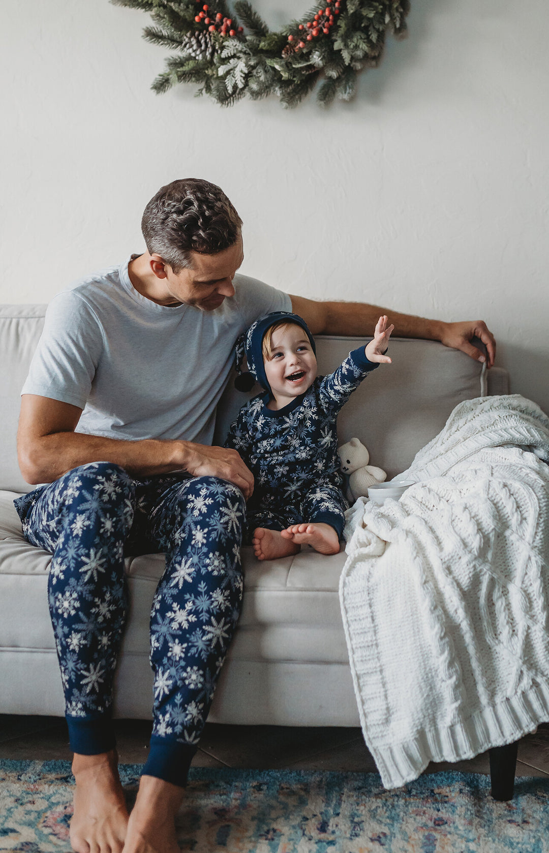 Child wearing Men's Organic Holiday Jogger & Cap Set in Snowflakes.