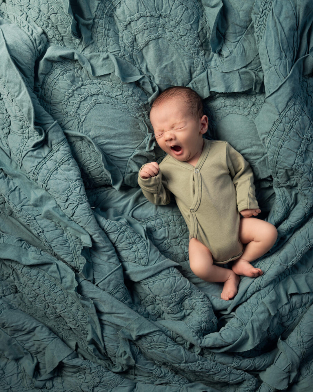 Child wearing Organic Kimono Bodysuit in Seafoam. 