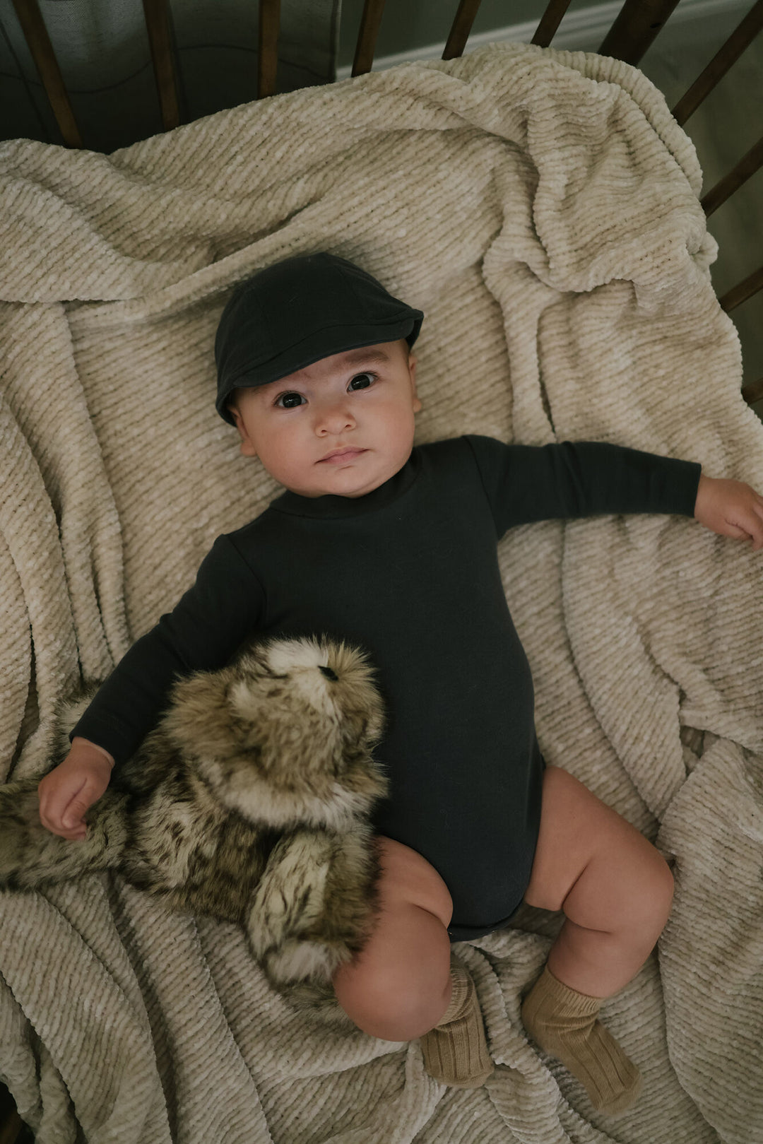 Child wearing Organic Mock-Neck Bodysuit in Charcoal.