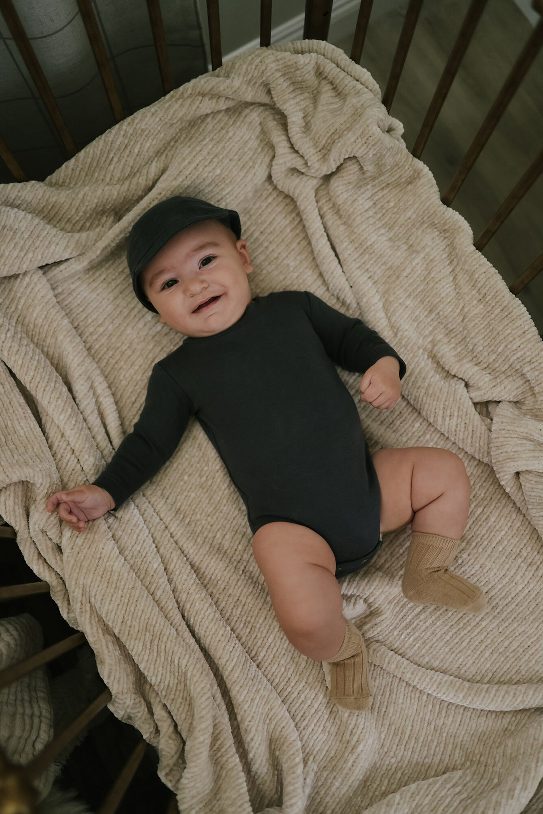 Child wearing Organic Mock-Neck Bodysuit in Charcoal.