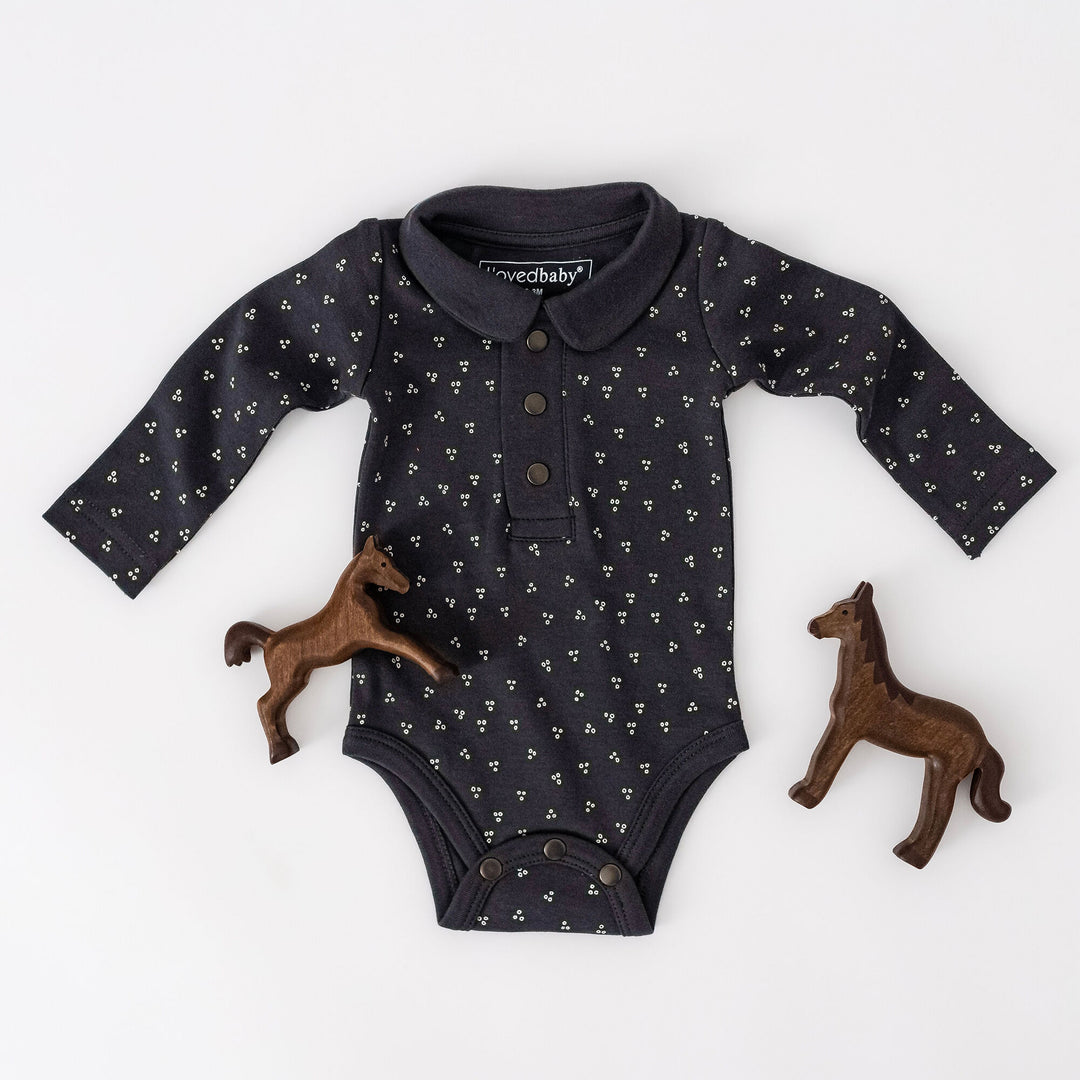 Child wearing Organic Polo Bodysuit in Charcoal Dots.